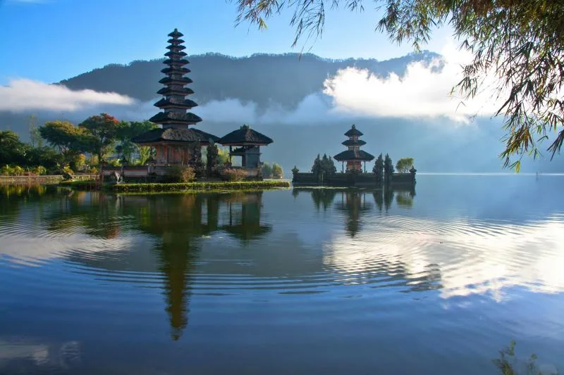 a lake with a pagoda and a building on it