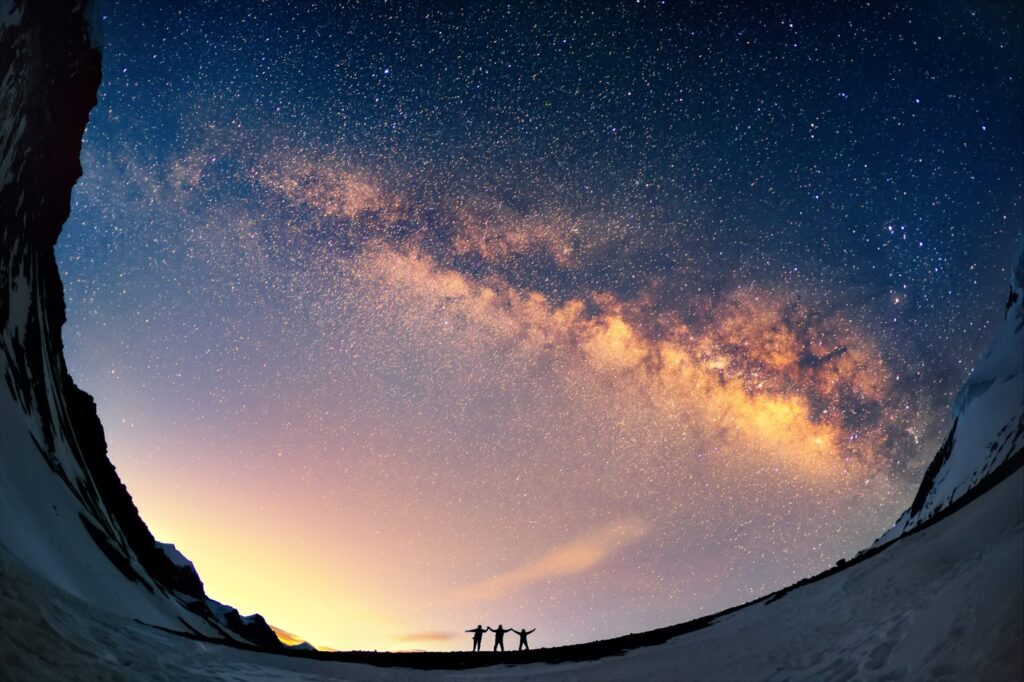 People standing looking at a sunset