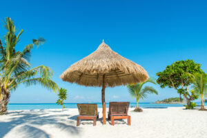 Summer, Travel, Vacation and Holiday concept - Beach Chairs and Umbrella on island in Phuket, Thailand