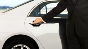 Chauffeur hand opening car door, guided tour